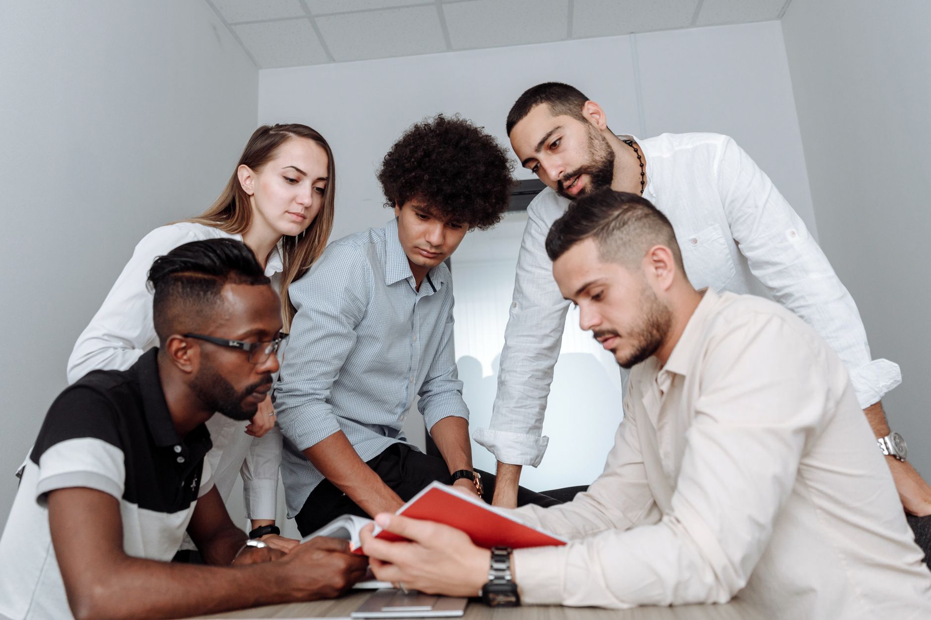 Project management team collaborating around a document